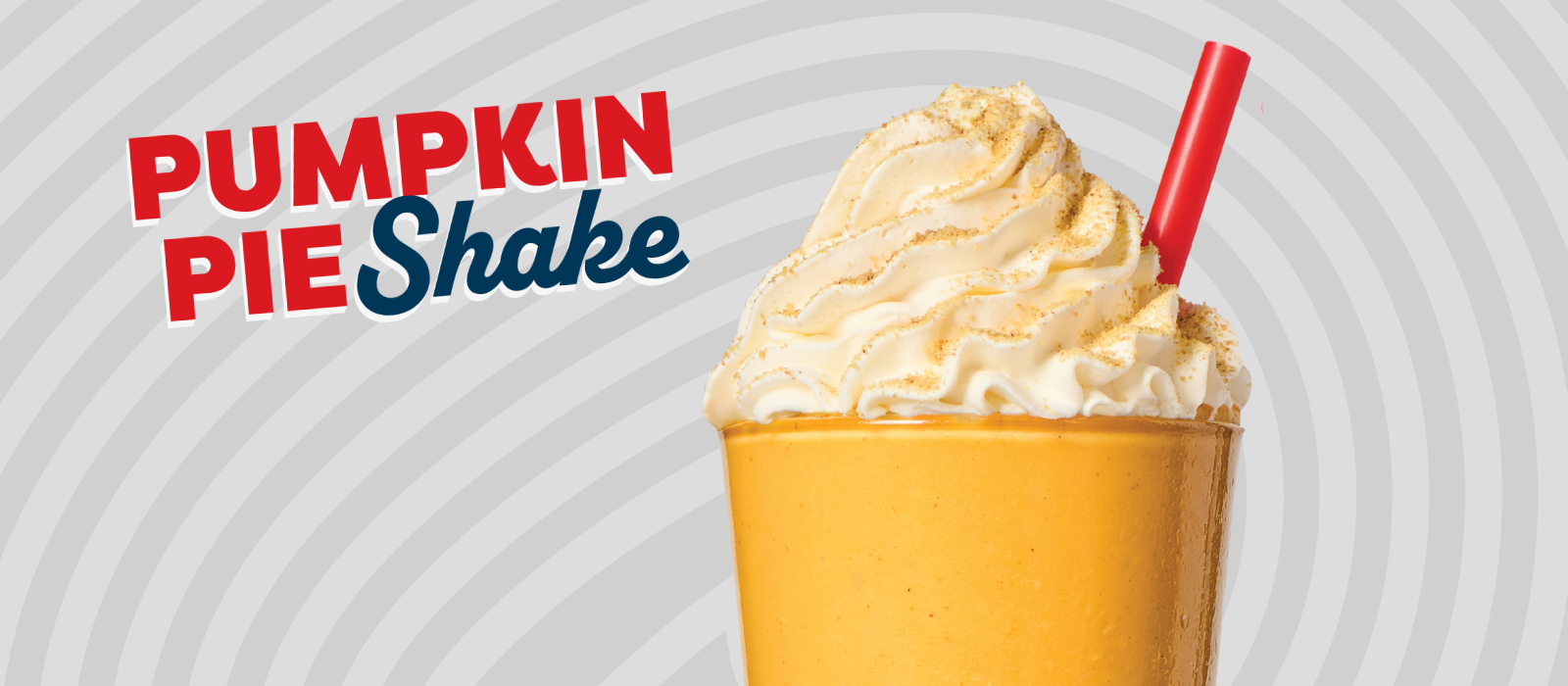 pumpkin shake topped with whipped cream and a red straw