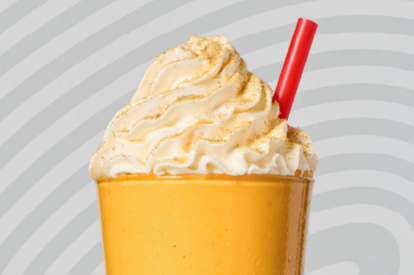 pumpkin shake with whipped cream and straw